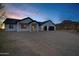 Exterior view of a home with a desert landscape, three-car garage and mountain views at 2438 N 113Th St, Mesa, AZ 85207