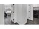 Hallway view of bedroom with tufted headboard and black stainless washer dryer at 2438 N 113Th St, Mesa, AZ 85207