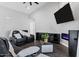 A living room features black leather reclining sofas, a faux fireplace, a TV, and modern decor at 2438 N 113Th St, Mesa, AZ 85207