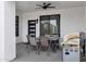 Covered patio area with ceiling fan, grill, dining table with six chairs and outdoor setting at 2438 N 113Th St, Mesa, AZ 85207