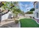 Landscaped backyard with an arched gate and fruit trees at 2542 S Playa --, Mesa, AZ 85202