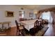 Bright dining room with hardwood flooring, large table with seating for ten, and view to kitchen at 2542 S Playa --, Mesa, AZ 85202