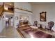 Spacious foyer featuring tiled flooring, a staircase, views of the dining area, and stylish seating at 2542 S Playa --, Mesa, AZ 85202