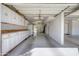 View of the 3 car garage with built in storage cabinets, epoxy floors, and bright lighting at 2542 S Playa --, Mesa, AZ 85202