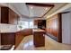 Well-lit kitchen with wooden cabinetry, an island, and stainless steel appliances at 2542 S Playa --, Mesa, AZ 85202