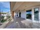 Covered outdoor patio showcases detailed tile floors, ample entertaining space, and access to a lush garden at 2542 S Playa --, Mesa, AZ 85202