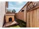 Side yard view showing a dog house and a wood fence at 25732 W St James Ave, Buckeye, AZ 85326