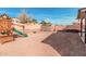 Backyard view showcases a play structure, storage shed and the block wall at 25732 W St James Ave, Buckeye, AZ 85326