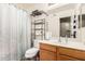 Practical bathroom with single sink vanity and shower with curtain at 25732 W St James Ave, Buckeye, AZ 85326