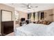 Well-lit bedroom with ceiling fan, dresser and adjacent bathroom access at 25732 W St James Ave, Buckeye, AZ 85326