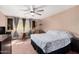 Serene bedroom featuring a ceiling fan, calming paint, and cozy seating area at 25732 W St James Ave, Buckeye, AZ 85326