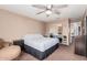 Spacious bedroom with a ceiling fan, plush seating and mirrored closet doors at 25732 W St James Ave, Buckeye, AZ 85326