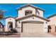 Beautiful two-story home featuring a well-manicured front yard, a fountain, and a spacious two-car garage at 25732 W St James Ave, Buckeye, AZ 85326