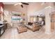 Cozy living room featuring tile flooring, a large window, and kitchen access at 25732 W St James Ave, Buckeye, AZ 85326