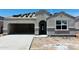 New home construction with a gray stucco exterior, a garage and stacked roof tiles at 28216 N Nealite Dr, San Tan Valley, AZ 85143