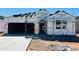 Under construction home featuring a two-car garage and a tile roof being installed at 28216 N Nealite Dr, San Tan Valley, AZ 85143