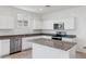 Contemporary kitchen with stainless steel appliances, white cabinetry, and a center island at 28216 N Nealite Dr, San Tan Valley, AZ 85143