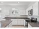 Modern kitchen featuring stainless steel appliances, white cabinets, and granite countertops at 28216 N Nealite Dr, San Tan Valley, AZ 85143