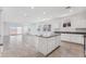 Open-concept kitchen with white cabinets, gray granite countertops, and a center island at 28216 N Nealite Dr, San Tan Valley, AZ 85143