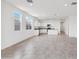 Open living space with a modern kitchen featuring white cabinets at 28216 N Nealite Dr, San Tan Valley, AZ 85143