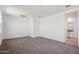 Carpeted living room has ample lighting and adjacent to full bathroom at 28216 N Nealite Dr, San Tan Valley, AZ 85143