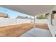 View from covered patio of the white concrete block fence and empty yard at 3026 W Ross Ave, Phoenix, AZ 85027