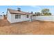 Backyard view showcases a covered patio area and a white-painted block fence at 3026 W Ross Ave, Phoenix, AZ 85027