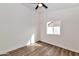 A clean, bright bedroom featuring a ceiling fan, neutral walls, and wood-look floors at 3026 W Ross Ave, Phoenix, AZ 85027