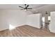 Open-concept living room with wood floors and a modern ceiling fan at 3026 W Ross Ave, Phoenix, AZ 85027