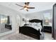 Light and airy bedroom with dark furniture, tile floors, a large window, and an archway leading to another room at 303 S 197Th Ave, Buckeye, AZ 85326