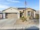 Charming home featuring a stone facade, neutral stucco, desert landscaping, and a two car garage at 303 S 197Th Ave, Buckeye, AZ 85326