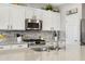 Close up of kitchen island featuring a double sink and stainless steel appliances at 303 S 197Th Ave, Buckeye, AZ 85326