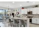 Bright kitchen features a large center island with countertop seating and white cabinets at 303 S 197Th Ave, Buckeye, AZ 85326