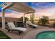 Outdoor patio area featuring a pergola, lounge chairs, and dining table, perfect for entertaining guests at 303 S 197Th Ave, Buckeye, AZ 85326