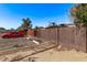 Assigned parking lot in the community featuring a parking spot behind a wooden privacy fence at 3120 N 67Th Ln # 31, Phoenix, AZ 85033