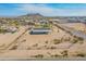 Expansive aerial view of a desert home featuring a vast lot and mountain backdrop at 31555 N Royce Rd, San Tan Valley, AZ 85144