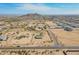 Expansive aerial view showcasing multiple homes and mountain landscape at 31555 N Royce Rd, San Tan Valley, AZ 85144