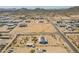 Vast aerial view of a desert homes with a mountain range backdrop at 31555 N Royce Rd, San Tan Valley, AZ 85144