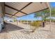 Backyard view showcasing a long, covered patio and inviting bench seating near desert landscape at 31555 N Royce Rd, San Tan Valley, AZ 85144