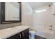 Bathroom featuring a vanity, toilet, and tub with white tile surround at 31555 N Royce Rd, San Tan Valley, AZ 85144