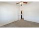 A neutral-colored bedroom with a ceiling fan and door leading into another room at 31555 N Royce Rd, San Tan Valley, AZ 85144