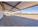 Spacious covered patio with unique stone-patterned flooring, offering ample outdoor living space and scenic desert views at 31555 N Royce Rd, San Tan Valley, AZ 85144