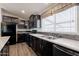 Open kitchen featuring granite counters, dark cabinets, and stainless steel appliances at 31555 N Royce Rd, San Tan Valley, AZ 85144