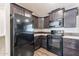 Modern kitchen featuring dark wood cabinets, stainless steel appliances, and laminate countertops at 31555 N Royce Rd, San Tan Valley, AZ 85144