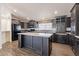 Modern kitchen featuring granite counters, dark cabinets, and a center island at 31555 N Royce Rd, San Tan Valley, AZ 85144