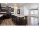 Spacious kitchen with wood cabinets, a large center island, and wood-look laminate flooring at 31555 N Royce Rd, San Tan Valley, AZ 85144