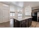 Open kitchen featuring wood cabinets, a large island with countertop, and stainless steel appliances at 31555 N Royce Rd, San Tan Valley, AZ 85144