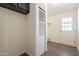 This is a laundry room with dark wood flooring and a white door leading to the outside at 31555 N Royce Rd, San Tan Valley, AZ 85144