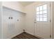 This is a laundry room with dark wood flooring and a white door leading to the outside at 31555 N Royce Rd, San Tan Valley, AZ 85144