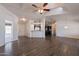 Spacious living area with wood flooring, flowing into the kitchen and entry way at 31555 N Royce Rd, San Tan Valley, AZ 85144